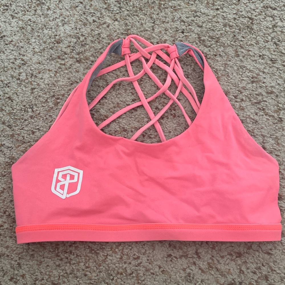 Gently used, but lots of love left! Beautiful coral sports bra with fun back!